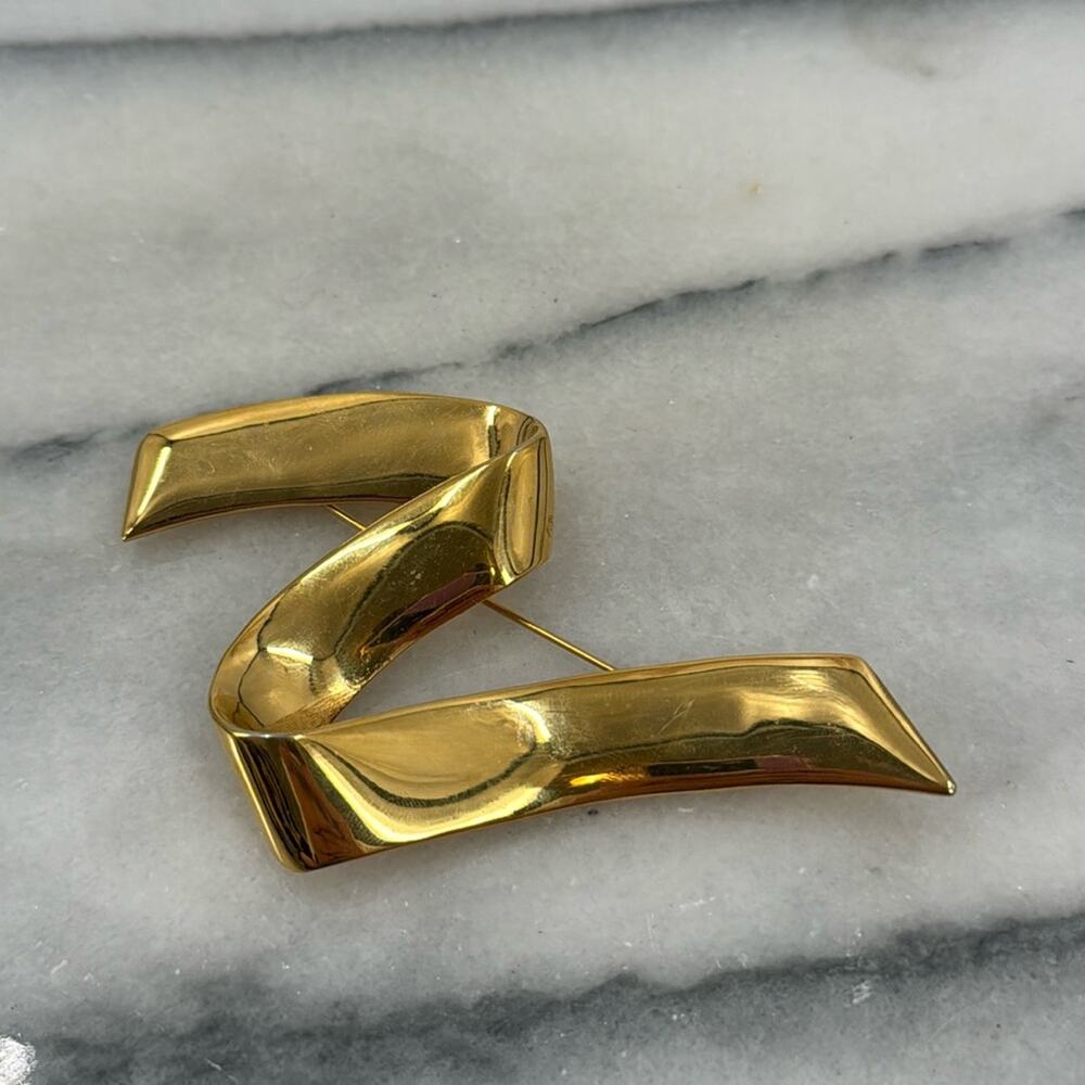 Vintage monet gold ribbon swoosh brooch